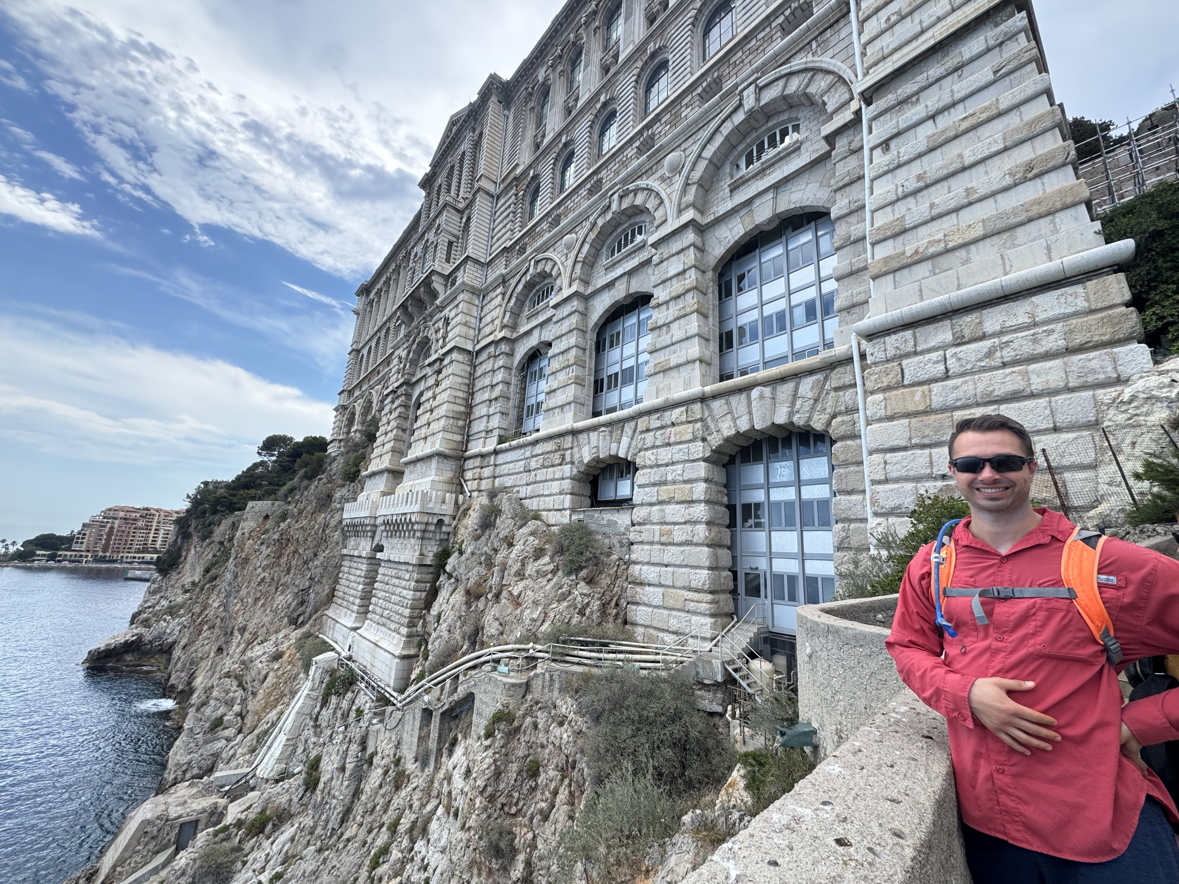 The Musée Océanographique de Monaco, a stone building built into a cliff face above the Mediterranean