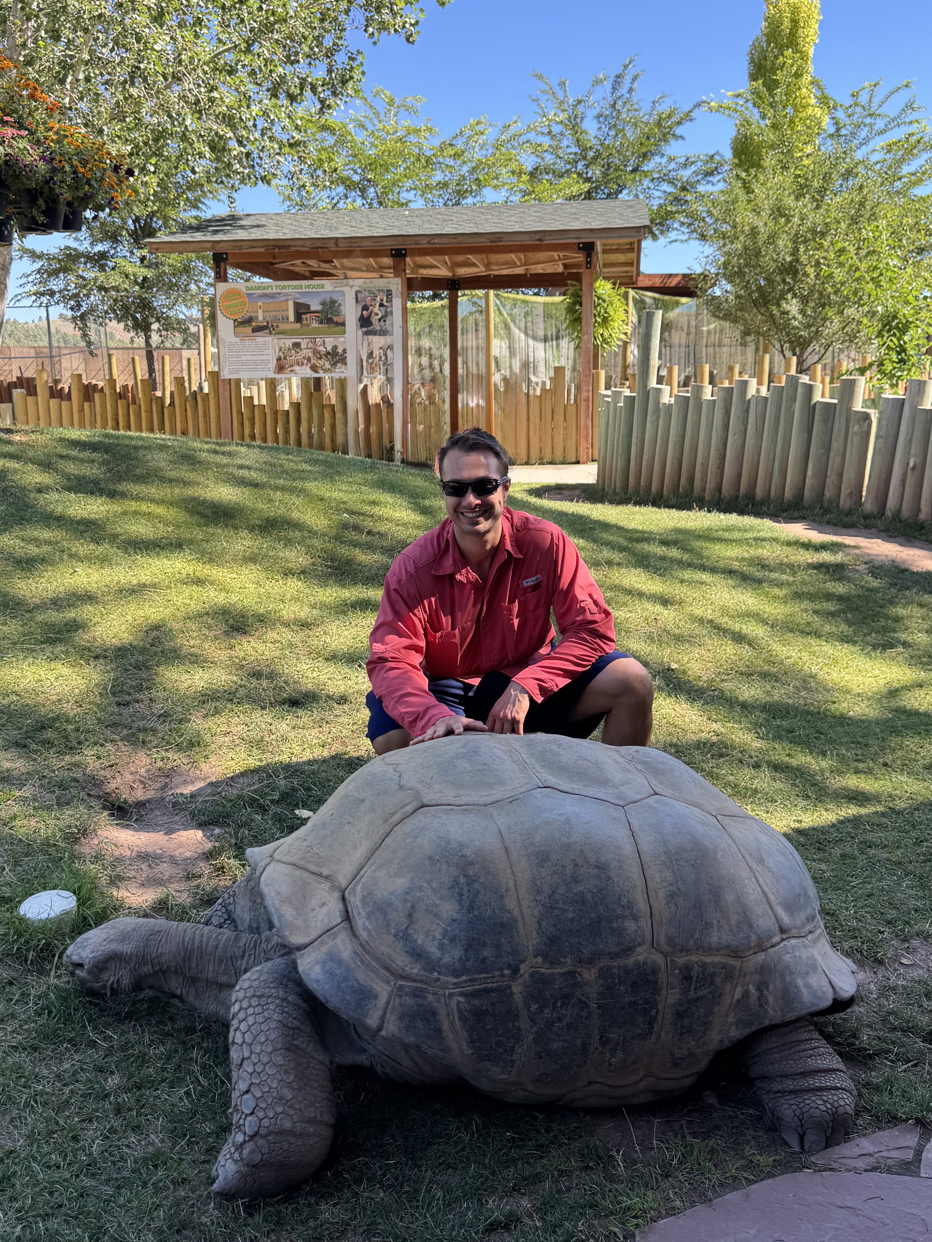 Dr. Alexander Reid with an Aldabra giant tortoise at Reptile Gardens in Rapid City, South Dakota